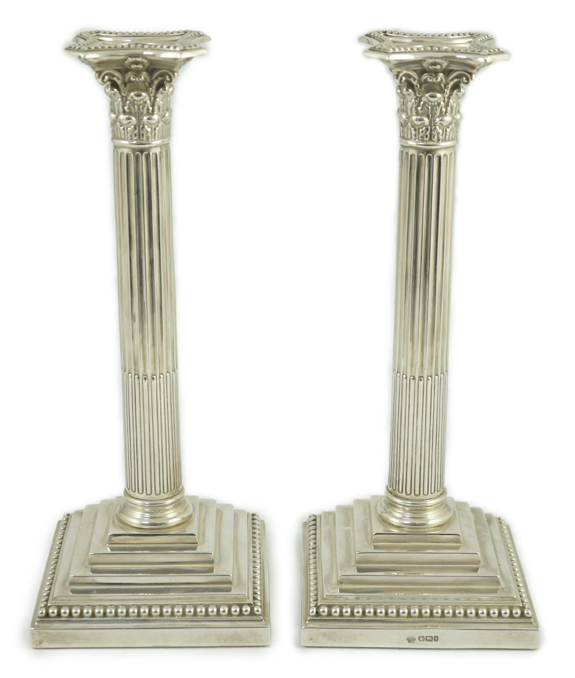 A pair of late Victorian silver Corinthian column candlesticks, by William Hutton & Sons